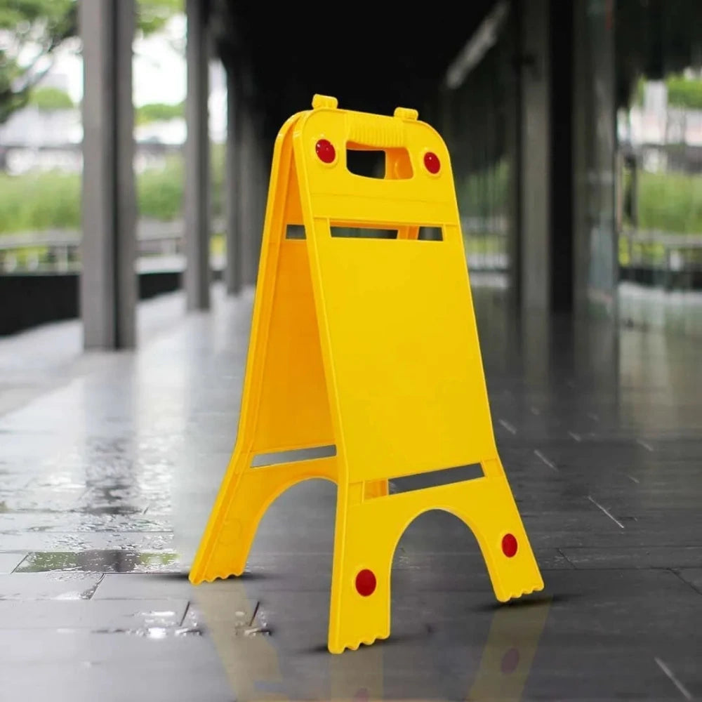Yellow wet floor sign on a wet pavement