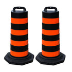 Two black and orange striped traffic safety barrel 