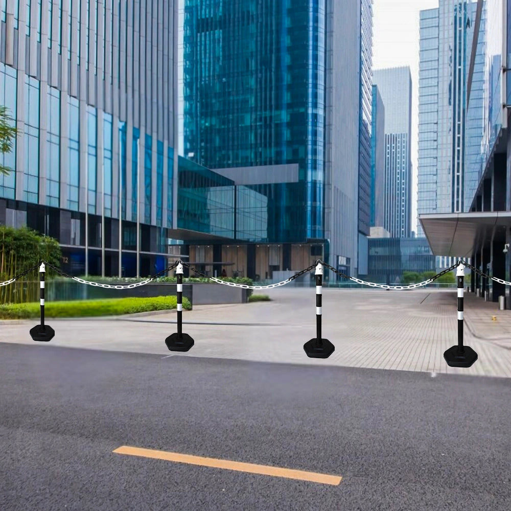 Barrier posts with white chains in front of modern high-rise buildings