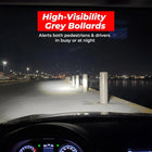 High-visibility grey bollards on a dock at night 