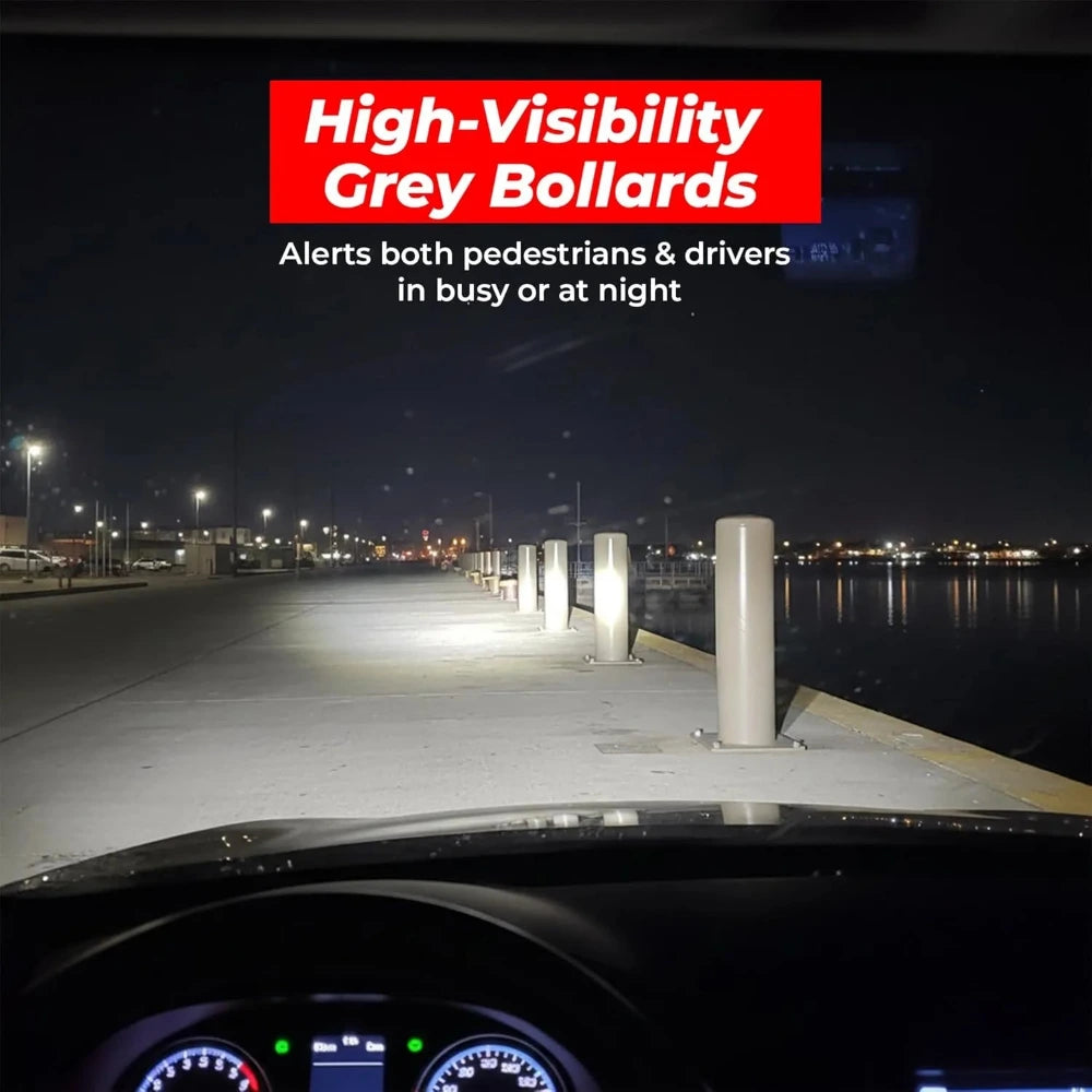 High-visibility grey bollards on a dock at night 