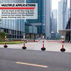 Barrier system with red and white posts on a city street with modern buildings 