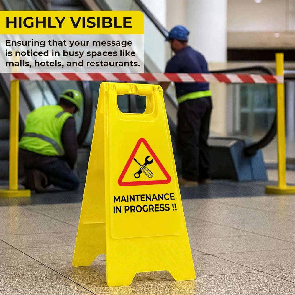 Yellow 'Maintenance in Progress' sign in a busy indoor setting with text about visibility.