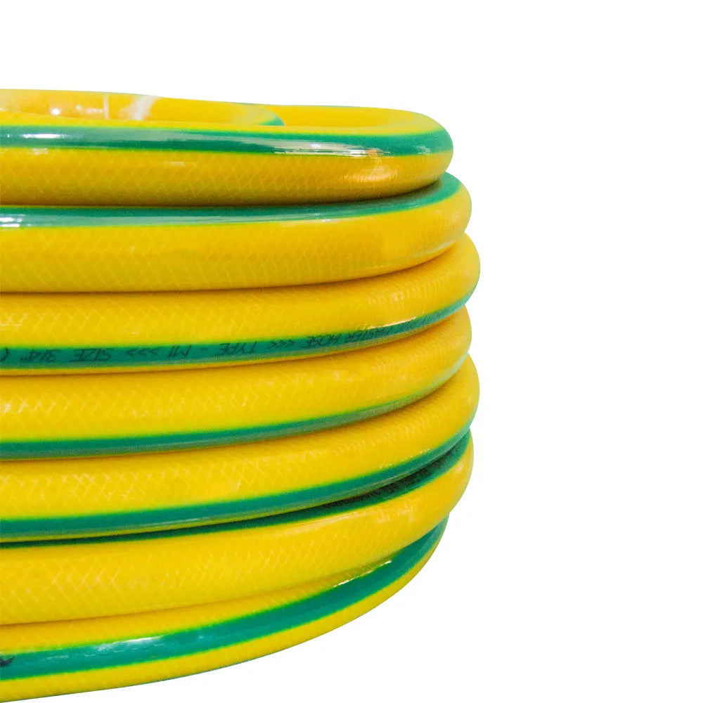 Coiled yellow and green garden hose on a white background