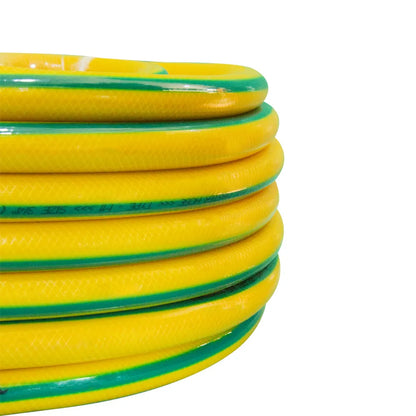 Coiled yellow and green garden hose on a white background