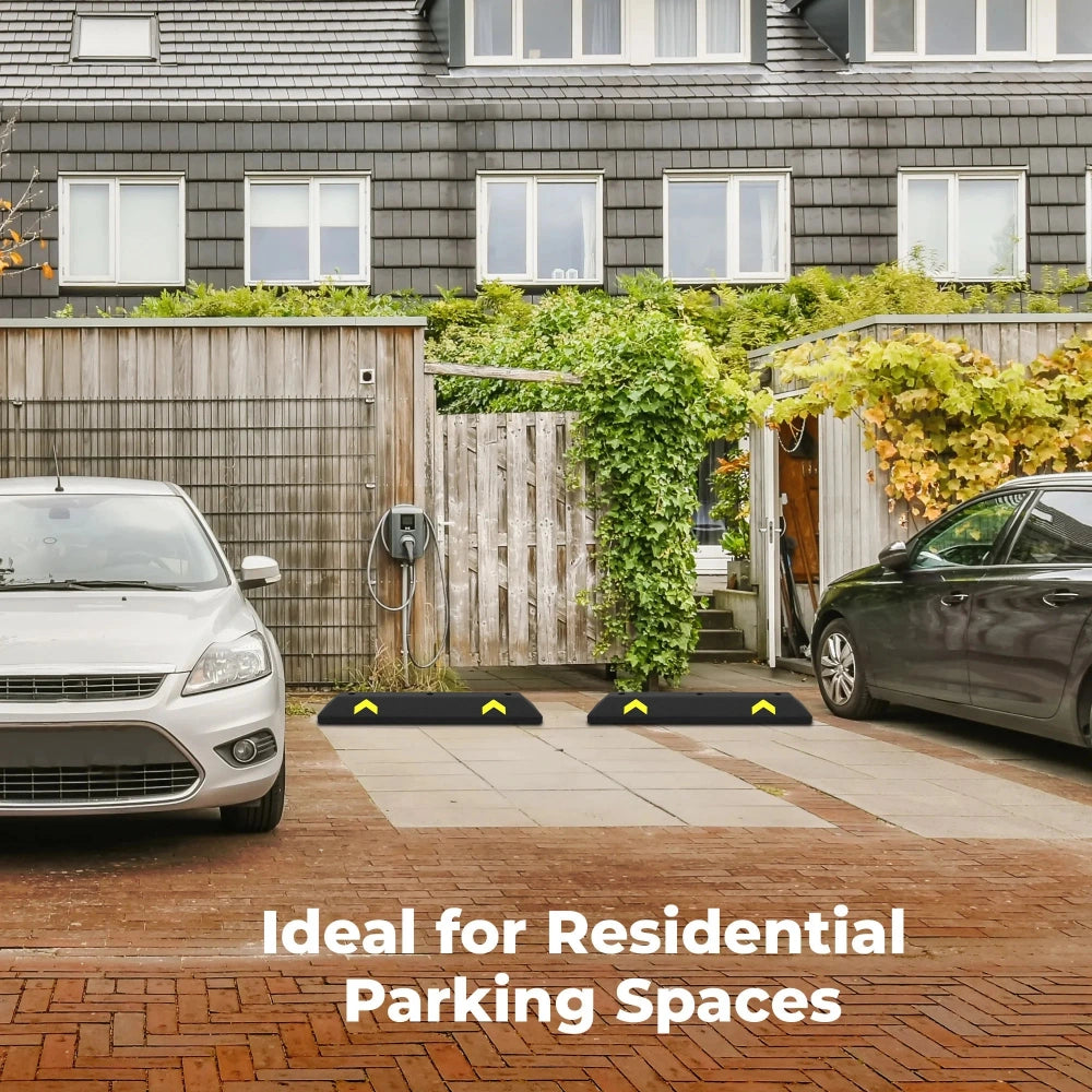 Two cars parked in a residential driveway with a house in the background.
