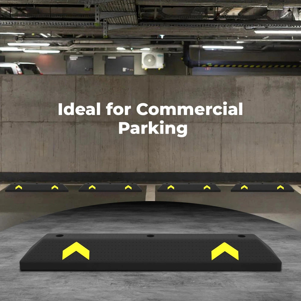 Black parking wheel stopper with yellow arrows on a concrete floor, ideal for commercial parking.