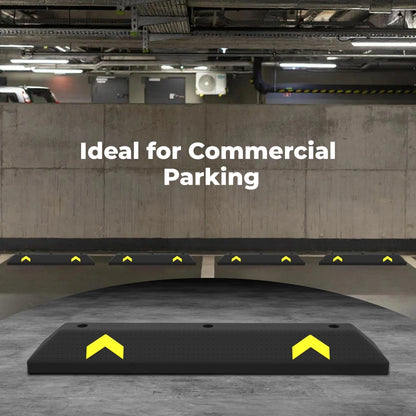 Black parking wheel stopper with yellow arrows on a concrete floor, ideal for commercial parking.