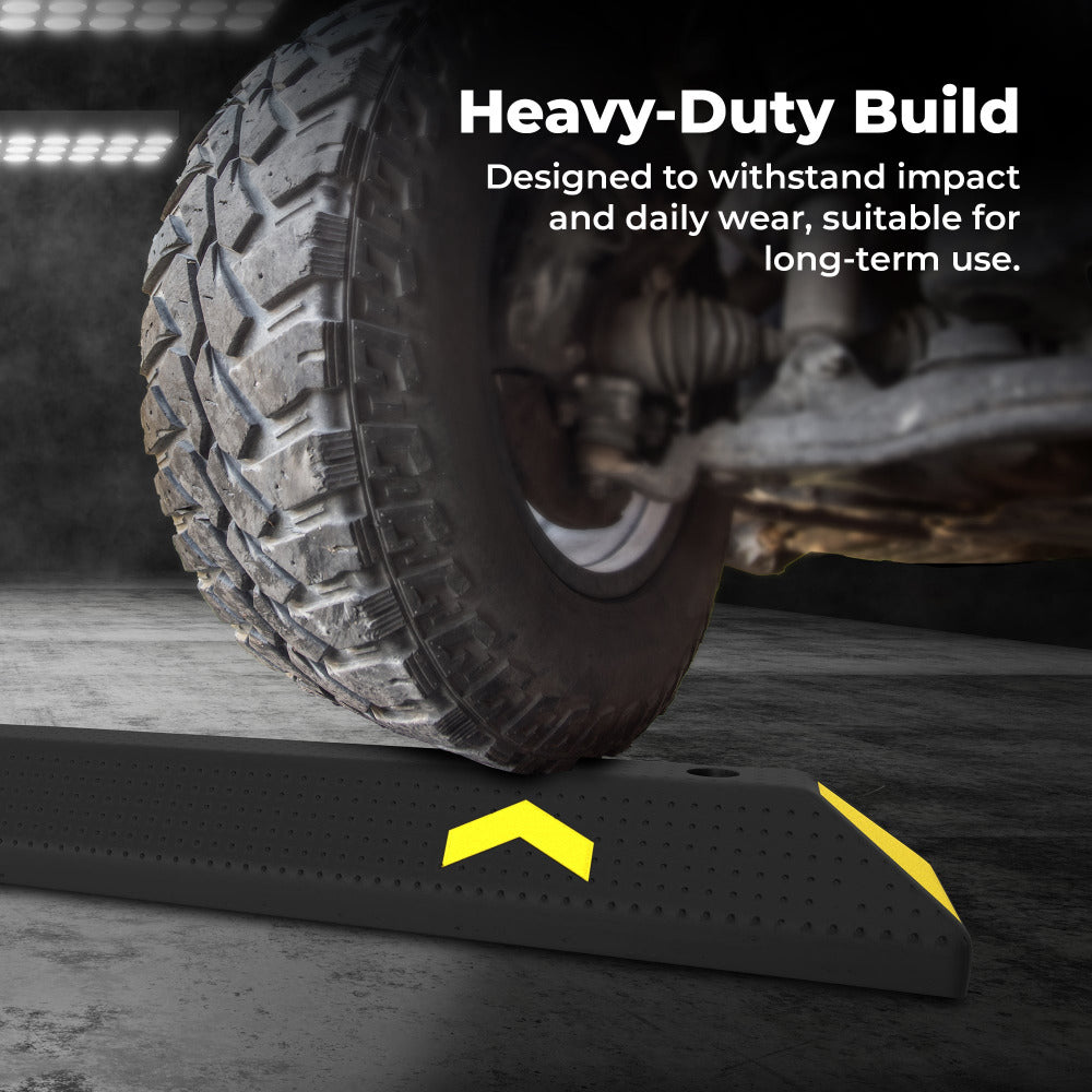Heavy-duty tire ramp with text highlighting durability, used on a concrete surface.