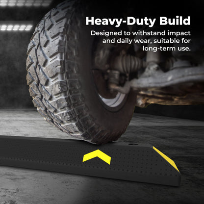Heavy-duty tire ramp with text highlighting durability, used on a concrete surface.