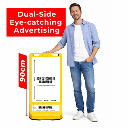 Man standing next to a yellow advertising board with customizable tex