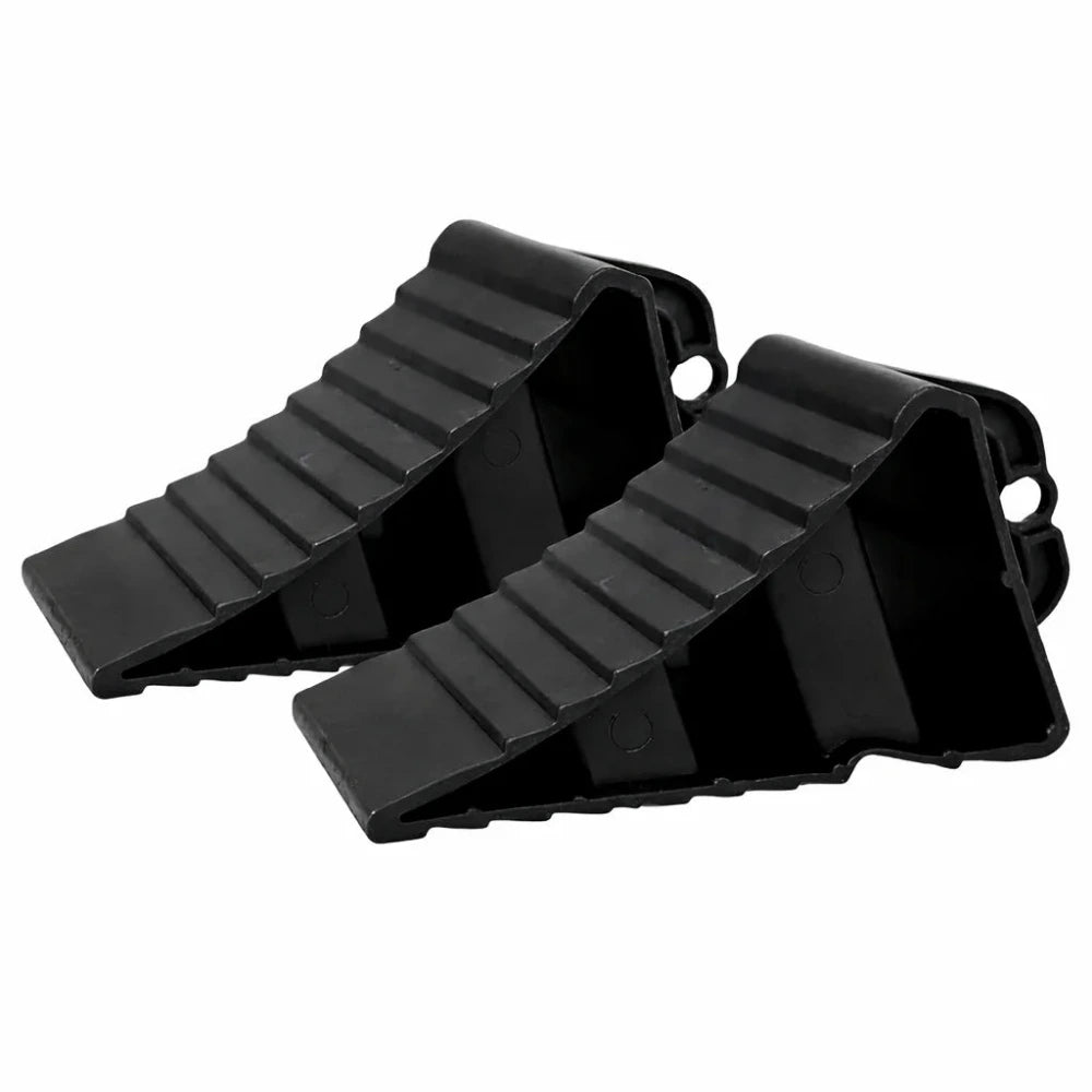 Two black plastic wedges on a white background