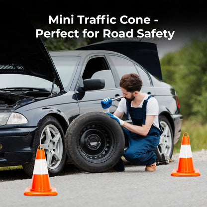 Person changing a tire with traffic cones on a road,