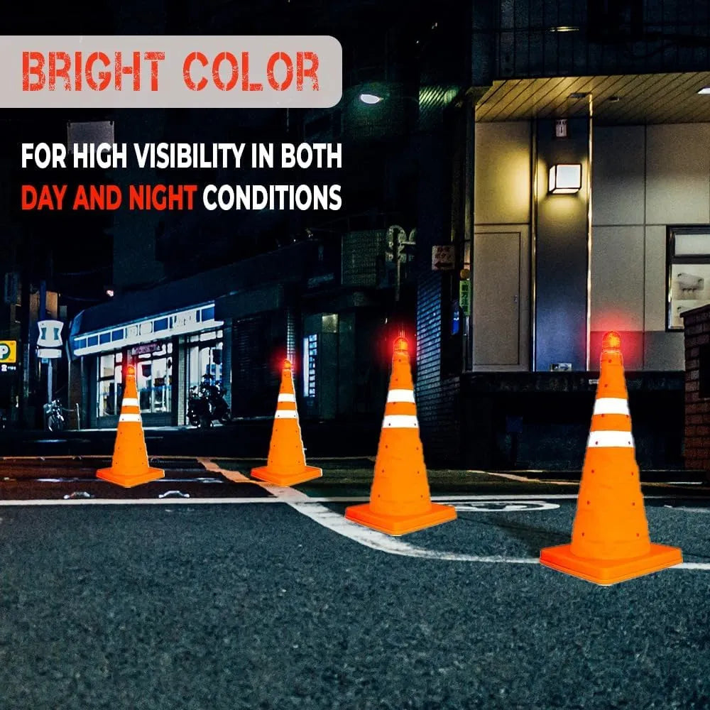 Four orange traffic cones on a street at night