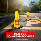 Two yellow traffic cones on a road with 'No Parking' signs