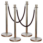 Set of four silver stanchion posts with black rope