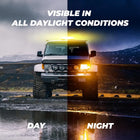 Off-road vehicle with lights on a mountain road